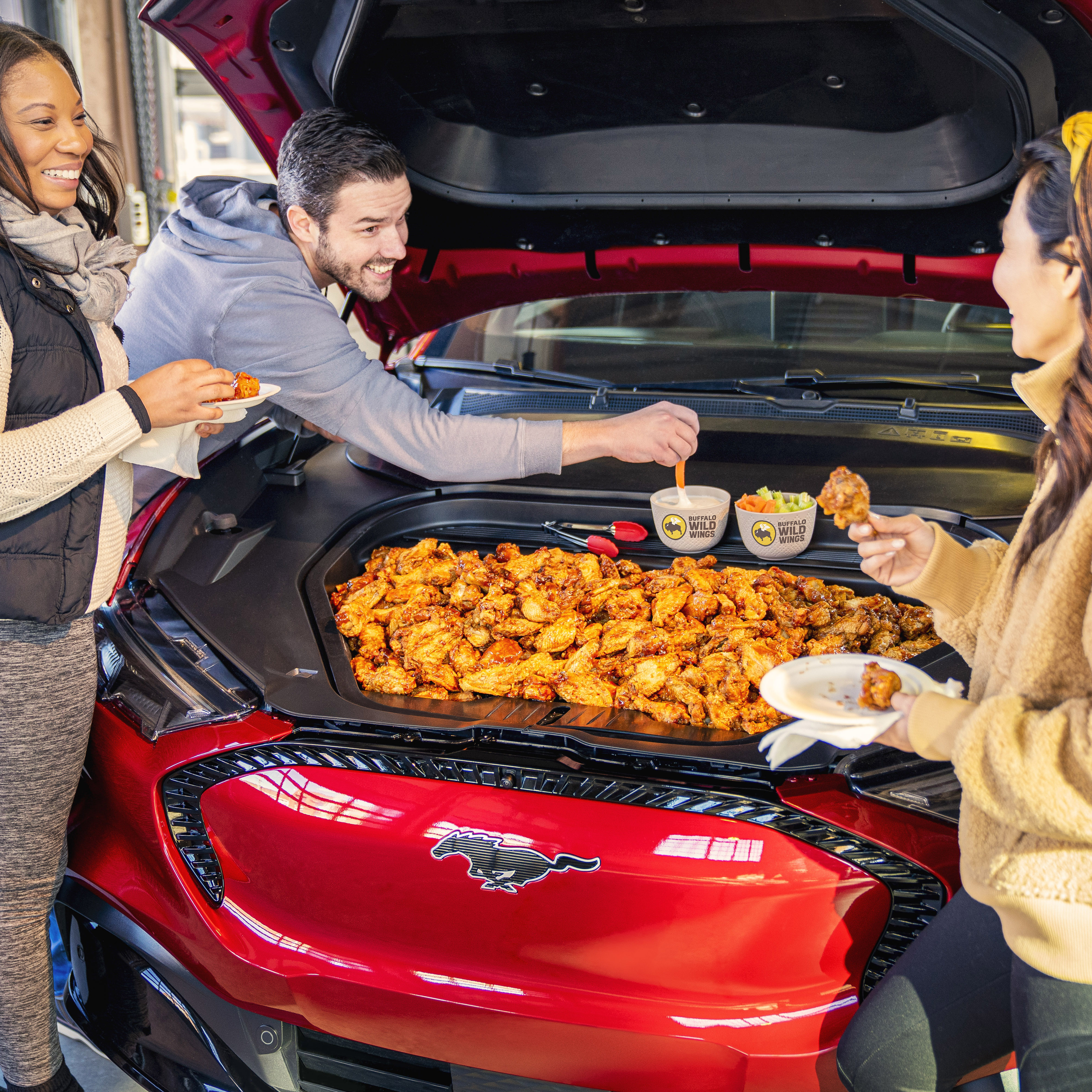 Football fans can elevate their tailgates for next season with the all-electric Mustang Mach-E’s front trunk, or frunk, a 4.8-cubic-foot plastic space – the equivalent to a 36-gallon cooler – that sits underneath the hood.